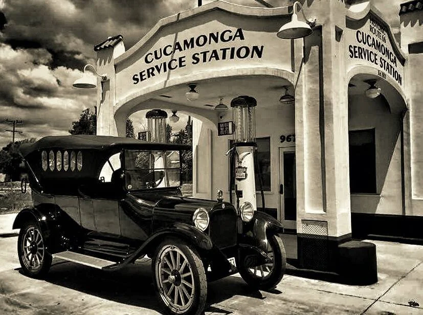 A restored Model T parked beneath the station's arched entrance